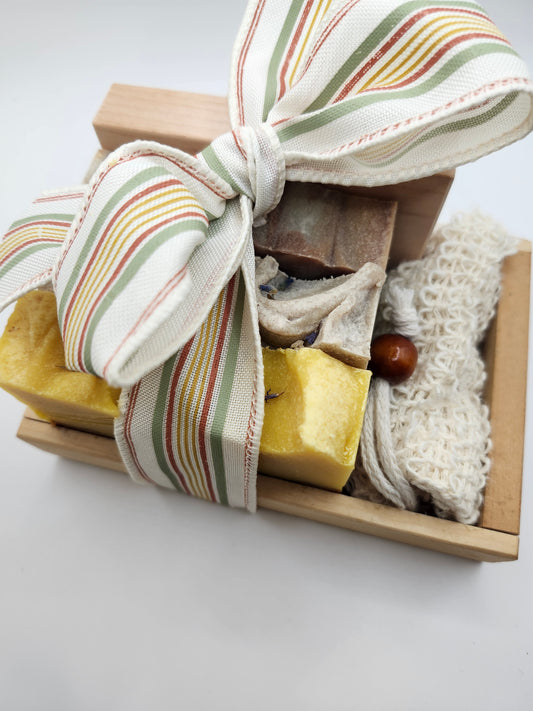 Handmade fall soap gift set in a wooden crate with striped ribbon bow, three artisan bar soaps, sisal soap saver and red alder soap di